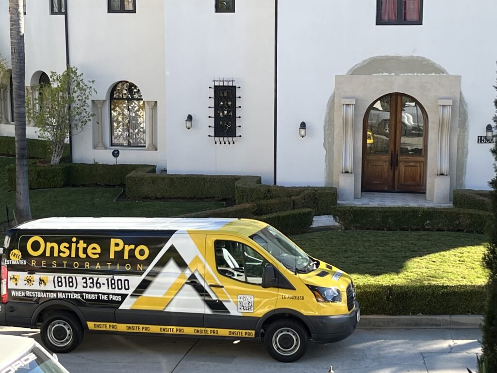 Onsite Pro Restoration van parked outside a house.