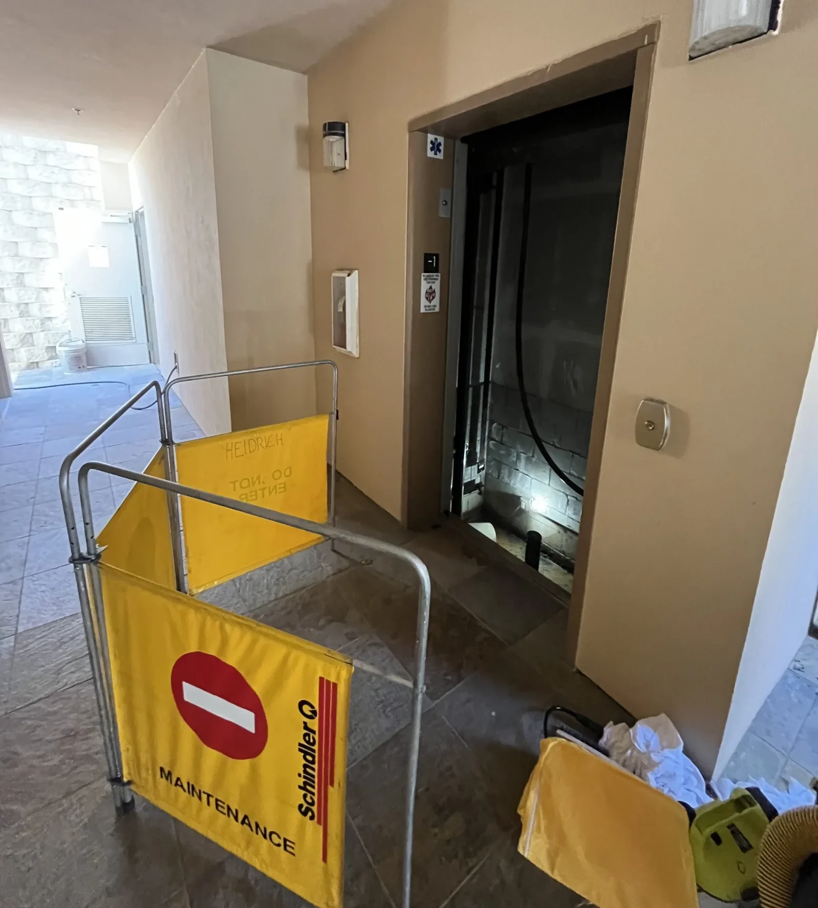 A blocked-off elevator shaft that has flooded.