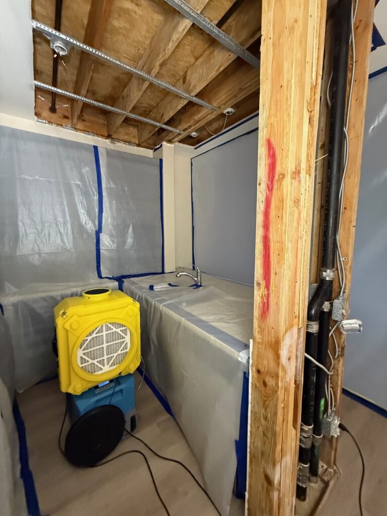 North Hollywood Damage Restoration Services | Onsite Pro 32 air scrubber and dehumidifier inside contained area